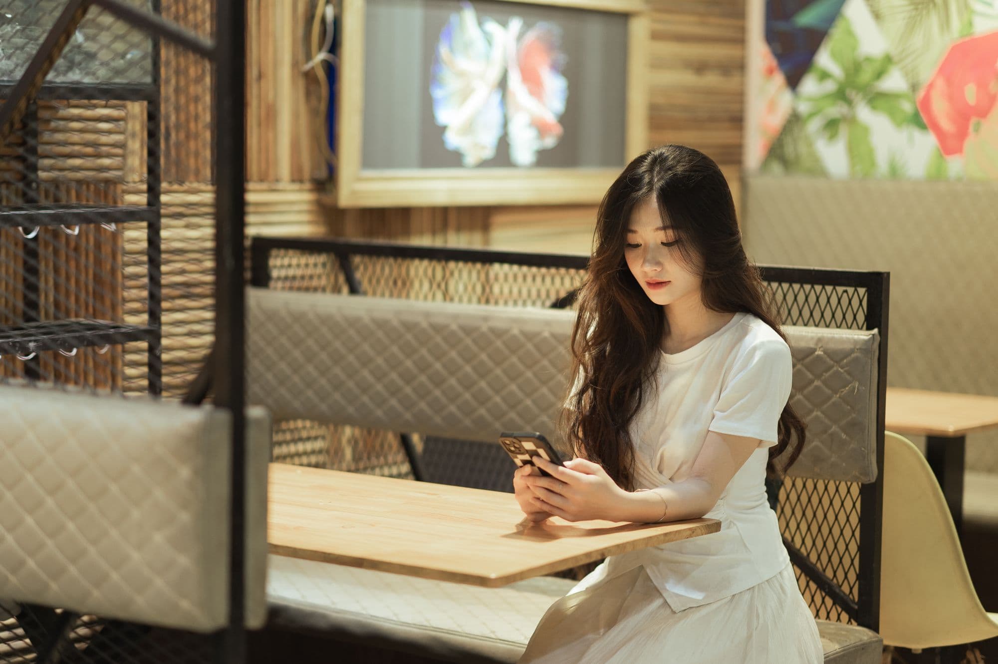 Restaurant owner reading a low Google review on a phone at a quiet table before service